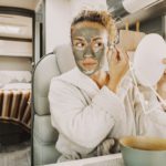 One pretty adult young woman busy in daily skin face care routine using natural green mask